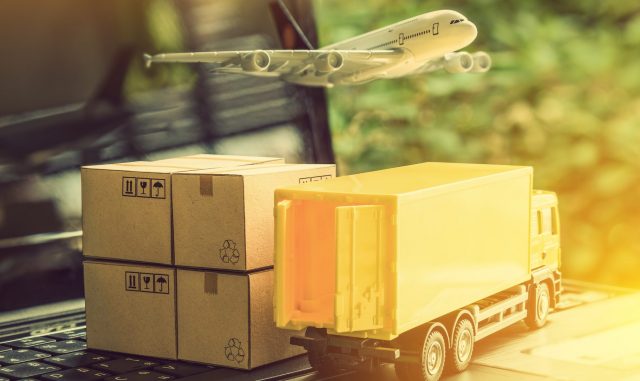 Air courier / freight forwarder or shipping service concept : Boxes, a truck, white plane flies over a laptop, depicts customers order things from retailer sites via the internet and ship worldwide.